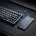 Keyboard, phone displaying “CONNECTED,” and USB adapter with wireless signal graphics